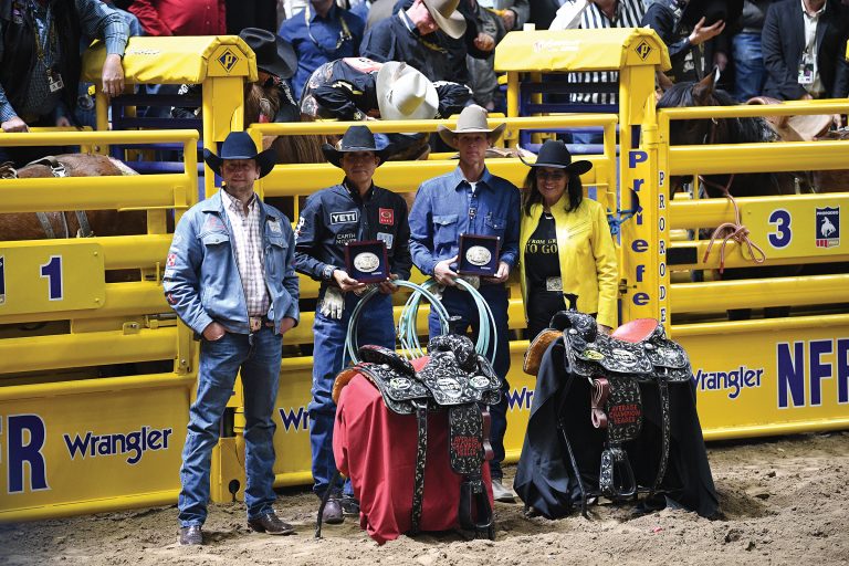 Judy Wagner presenting NFR Average Champions Derrick Begay and Colter Todd their Montana Silversmiths buckles after Round 10 in 2023.