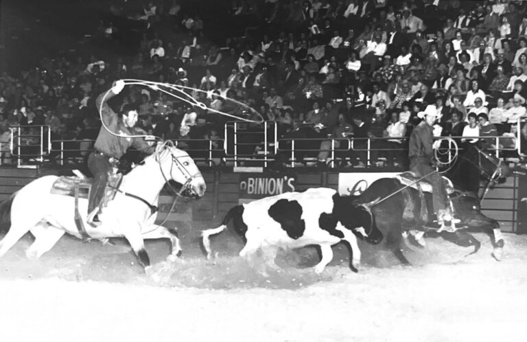 black and white photo of a young Jake Barnes roping with Leo Camarillo
