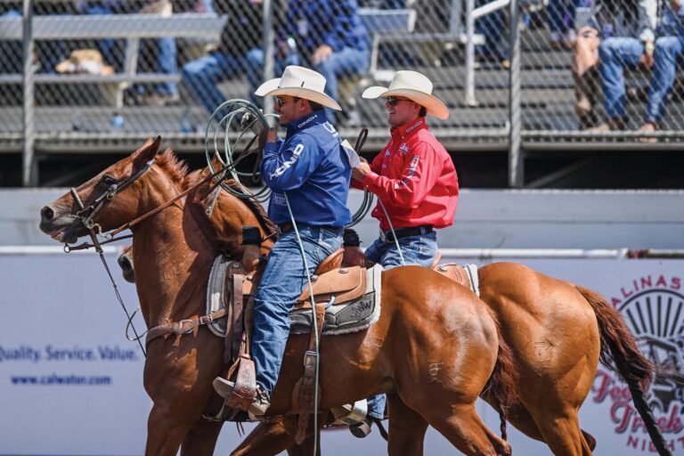 Coy Rahlmann and Jonathan Torres riding next to each other at California Rodeo Salinas